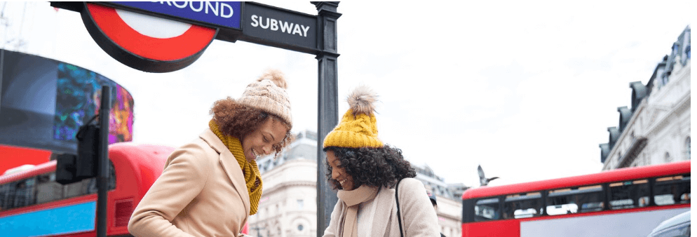 women in front of sign women in front of sign